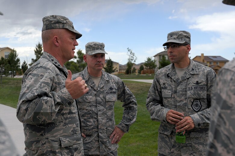 Lt. Gen. Jay Raymond, 14th Air Force commander, and Chief Master Sgt. Patrick McMahon, 14 AF command chief, talk with Col. Bill Liquori, 50th Space Wing commander, during their visit June 30, 2014, at Schriever Air Force Base, Colo. During their visit, Raymond and McMahon toured 1st, 2nd 3rd, 4th and 22nd Space Operations Squadrons, 50th Operations Support Squadron and 50th Security Forces Squadron. (U.S. Air Force photo/Christopher DeWitt)