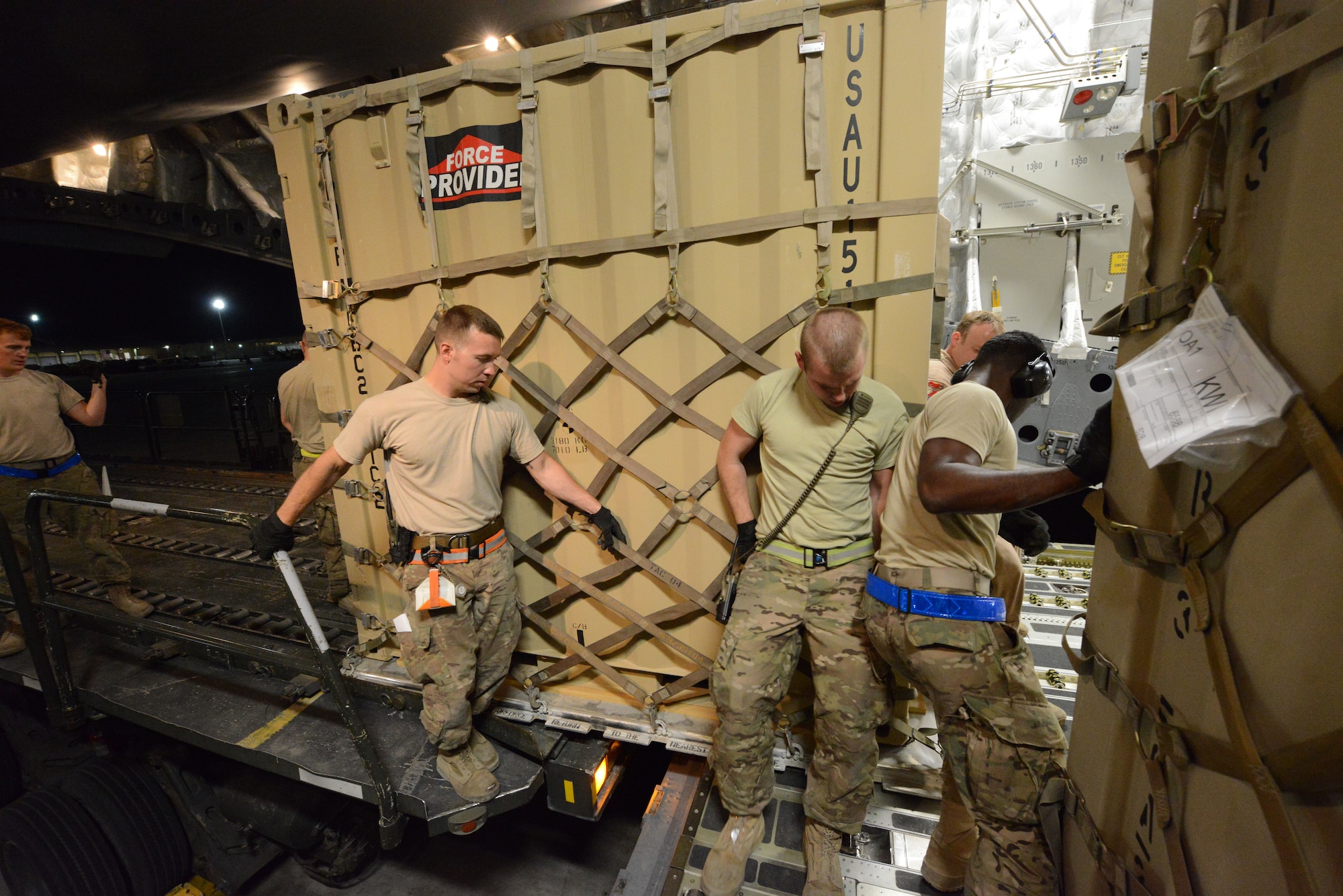 U.S. Air Force Airmen assigned to the 455th Expeditionary Aerial Port Squadron work together to move a pallet forward onto a C-17 Globemaster III at Bagram Airfield, Afghanistan June 21, 2014. (U.S. Air Force photo by Master Sgt. Cohen A. Young/Released)
