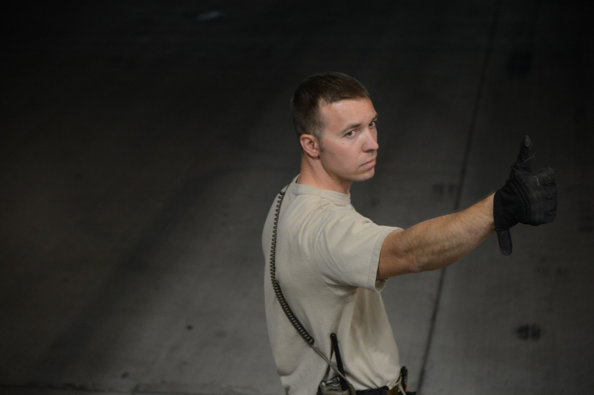 U.S. Air Force Staff Sgt. Michael Otto, a native of Fremont, Wisc., and currently assigned to the 455th Expeditionary Aerial Port Squadron gives the ‘thumbs up’ signal to a loadmaster to ensure it’s okay to move a K-loader toward a C-17 Globemaster in an effort to begin loading cargo aboard the aircraft at Bagram Airfield, Afghanistan June 21, 2014. Otto, is deployed from the 305th Aerial Port Squadron, McGuire Air Force Base, N.J.  (U.S. Air Force photo by Master Sgt. Cohen A. Young/Released)