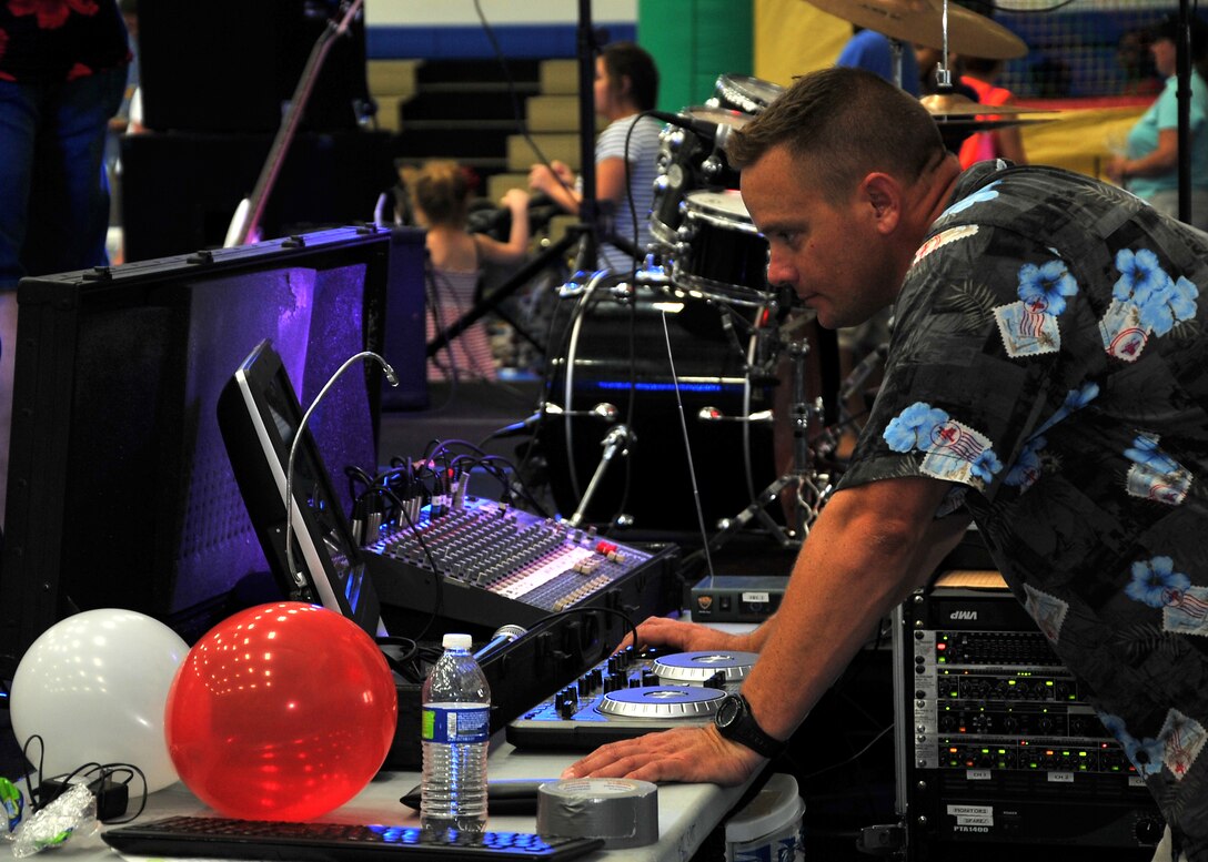 Capt. Brian Slater, 36th Security Forces Squadron, serves as disc jockey for the Freedom Fest event July 4, 2014, on Andersen Air Force Base, Guam. More than 600 military members and their families attended the Freedom Fest at the Coral Reef Fitness Center in celebration of Independence Day.  (U.S. Air Force photo by Staff Sgt. Melissa B. White/Released)
