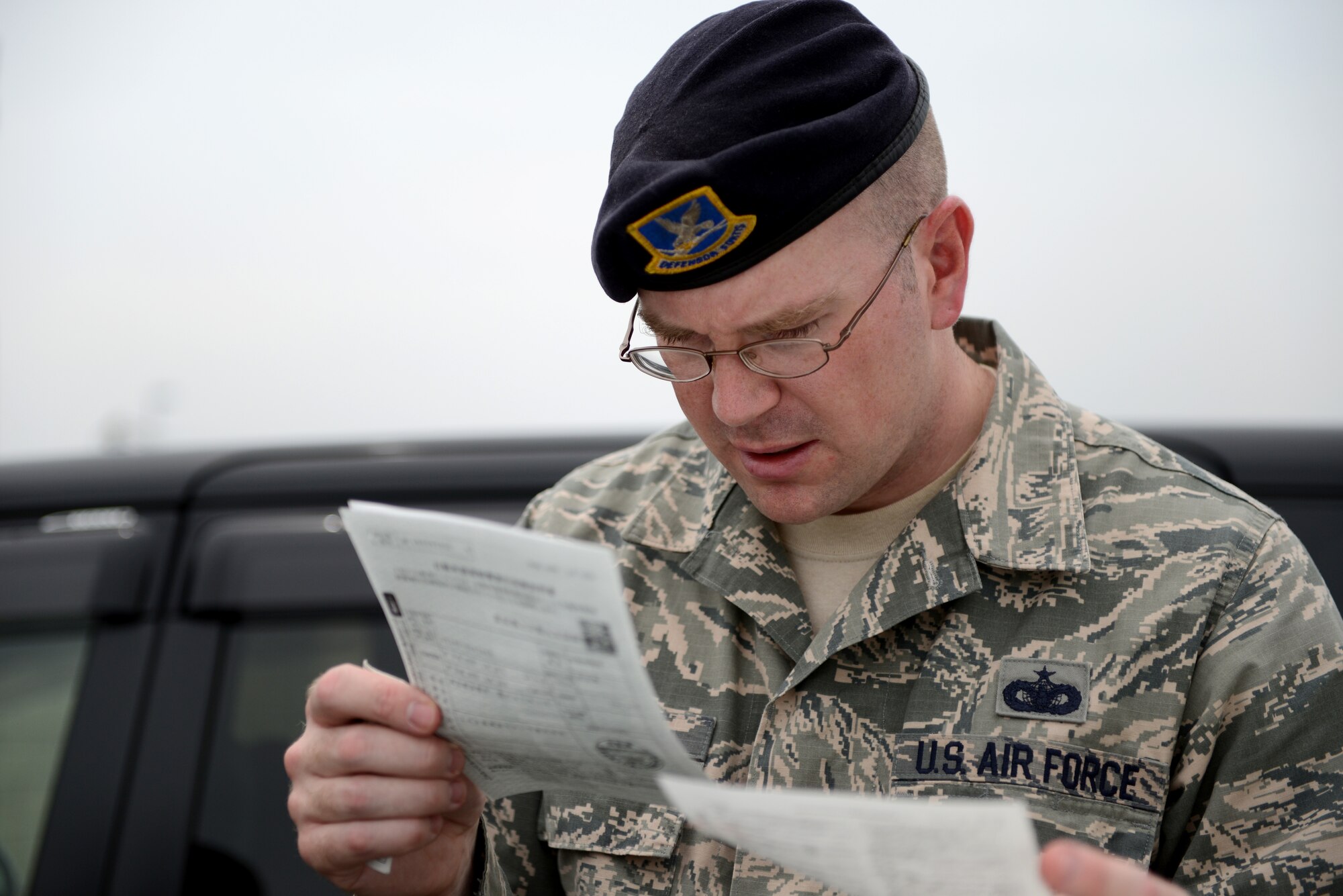 Tech. Sgt. Davy Hoffman, 374th Security Forces Squadron unit resource advisor, checks a U.S. Forces, Japan, operator’s permit for a civilian vehicle during a traffic safety surge at Yokota Air Base, Japan, July 3, 2014. The traffic safety surge was intended to ensure the Yokota community was driving legally and safely before the long holiday weekend. (U.S. Air Force photo by Senior Airman Cody H. Ramirez/Released)