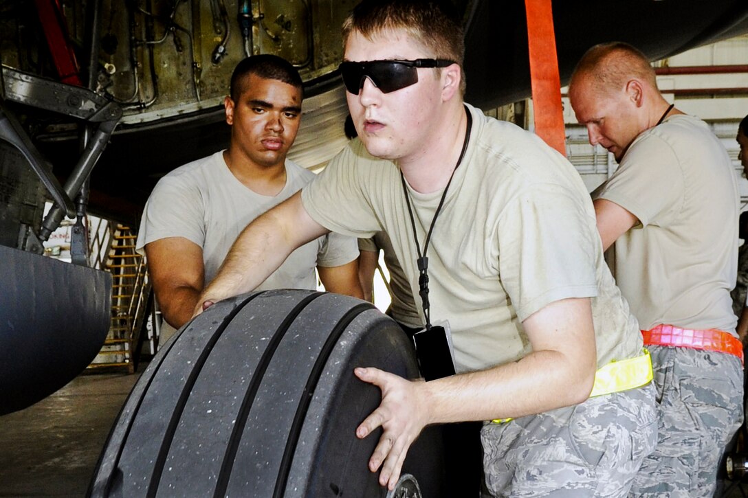 U.S. Air Force Senior Airman Joshua Sloan replaces a tire on a KC-135 Stratotanker on Kadena Air Base, Japan, July 6, 2014, to prepare to move it off the island in advance of a massive typhoon expected to hit Okinawa.