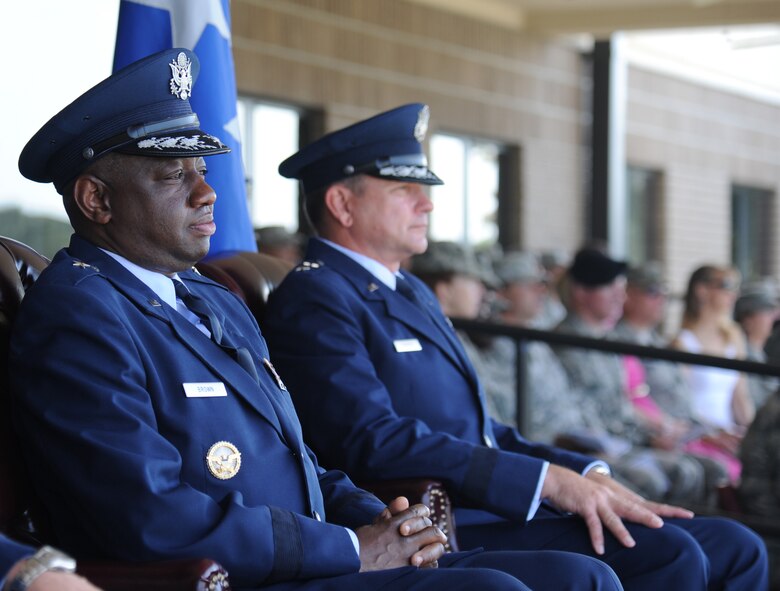 Brig. Gen. Mark Brown, incoming 2nd Air Force commander, and Maj. Gen. Leonard Patrick, outgoing commander, watch the troops as they prepare to march during pass and review following the 2nd Air Force change of command ceremony July 3, 2014, at Keesler Air Force Base, Miss.  Brown was previously the Financial Management director, Headquarters Air Force Material Command at Wright-Patterson Air Force Base, Ohio. Patrick is headed to Randolph Air Force Base, Texas, where he will become the AETC vice commander.  (U.S. Air Force photo by Kemberly Groue)
