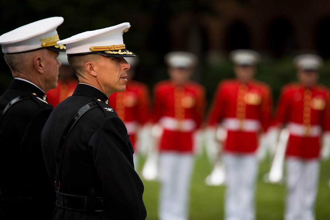 Col. Benjamin Watson, Marine Barracks Washington, D.C. commanding officer, and Gen. James Amos, commandant of the Marine Corps, watch as the U.S. Marine Drum & Bugle Corps performs during the retirement ceremony of Lt. Gen. Richard Tryon, commander of U.S. Marine Corps Forces Command and U.S. Marine Corps Forces Europe, at the Barracks, July 9, 2014. Tryon enlisted in the Navy in 1970 and was commissioned a 2nd Lt. in the Marine Corps in 1975. (Official Marine Corps photo by Cpl. Dan Hosack/ Released) 