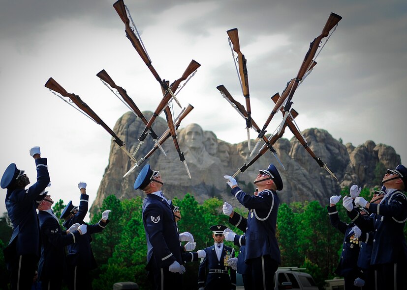 The U.S. Air Force Honor Guard Drill Team performs June 26, 2014, at Mount Rushmore. The Drill Team recently completed a nine-day, seven-city, 10-performance tour across the Midwest with the U.S. Air Force Band’s rock ensemble Max Impact. During the tour, the two groups performed in Wisconsin, Minnesota, South Dakota, Wyoming and Nebraska. (U.S. Air Force Photo/1st Lt. Nathan Wallin)