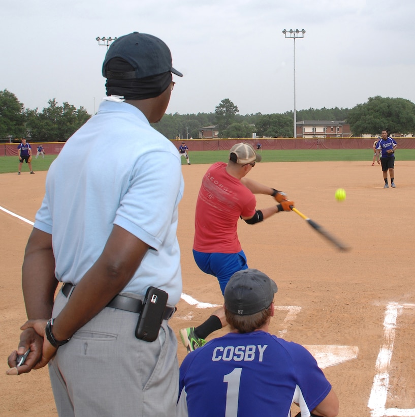 Dustin Smith of Weapons hits a softball into center field July 3 during an intramural softball game at Crouch Field aboard Marine Corps Logistics Base Albany. Weapons dominated Sons of Pitches, 21-2.