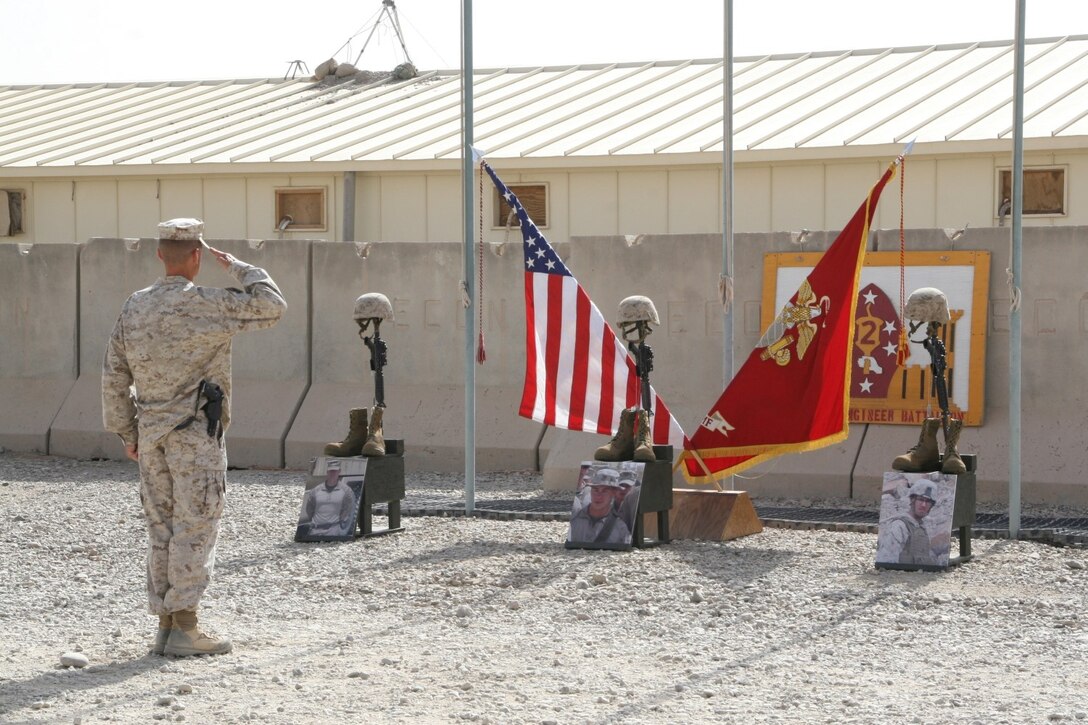 Lieutenant Col. John C. Osborne, commanding officer, 2nd Combat Engineer Battalion, salutes the battlefield crosses during a memorial ceremony aboard Camp Leatherneck, Afghanistan, July 8, 2014, to pay his respect to three Marine heroes. Three battlefield crosses stand in honor of, from left to right, Staff Sgt. David H. Stewart, a combat engineer, platoon sergeant and native of Stafford, Virginia; Cpl. Brandon J. Garabrant, a combat engineer and native of Peterborough, New Hampshire; and Cpl. Adam F. Wolff, a combat engineer and native of Cedar Rapids, Iowa, all Marines serving with 3rd Platoon, Route Clearance Company, 2nd CEB, who gave the ultimate sacrifice while conducting combat operations in Helmand province, Afghanistan, June 20, 2014.