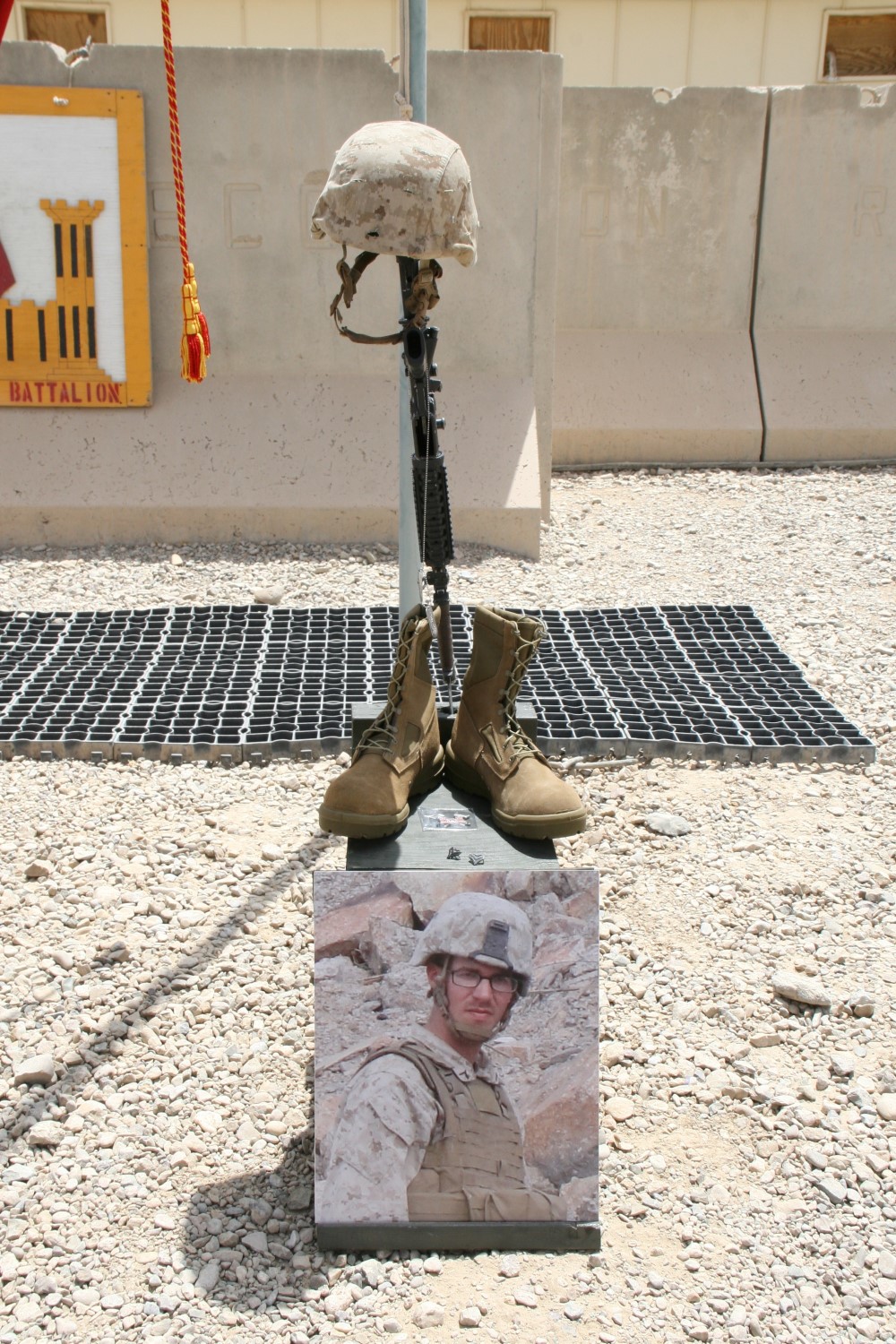 A  battlefield cross stands in honor of Cpl. Adam F. Wolff, combat engineer, 3rd Platoon, Route Clearance Company, 2nd Combat Engineer Battalion, and native of Cedar Rapids, Iowa, during a memorial ceremony aboard Camp Leatherneck, Afghanistan, July 8, 2014. Wolff was killed while conducting combat operations in Helmand province, June 20, 2014.