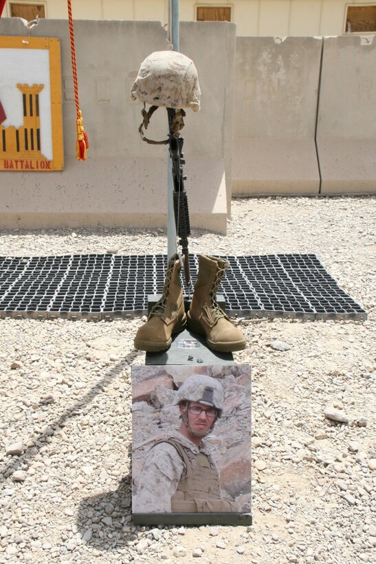 A  battlefield cross stands in honor of Cpl. Adam F. Wolff, combat engineer, 3rd Platoon, Route Clearance Company, 2nd Combat Engineer Battalion, and native of Cedar Rapids, Iowa, during a memorial ceremony aboard Camp Leatherneck, Afghanistan, July 8, 2014. Wolff was killed while conducting combat operations in Helmand province, June 20, 2014.