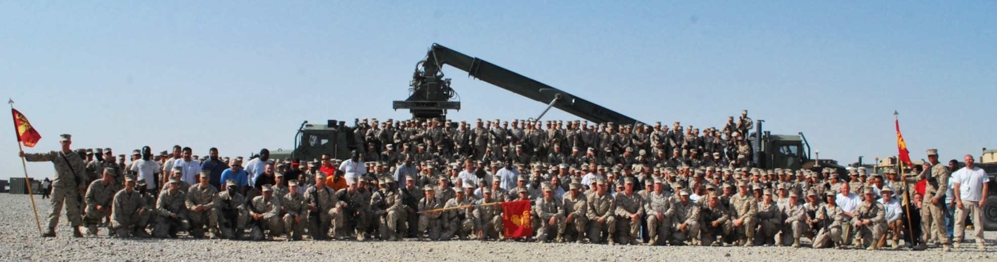 Marines and civilian contractors with Redeployment and Retrograde in support of Reset and Reconstitution Operations Group pose for a unit photo recently during their current deployment to Camp Leatherneck, Helmand province, Afghanistan. The unit was established aboard the base during April 2012, tasked with the significant role as the unit responsible to retrograde all Marine Corps gear home from Afghanistan.