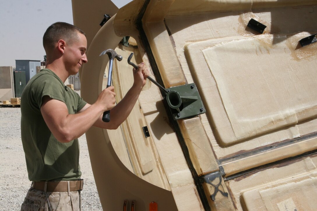 Corporal Jordan A. Yokum, a preservation, packaging and packing specialist with Redeployment and Retrograde in support of Reset and Reconstitution Operations Group, works on a piece of equipment that was removed from a tactical vehicle aboard Camp Leatherneck, Helmand province, Afghanistan, July 1, 2014. R4OG was established during April 2012 and has a significant role as the unit responsible for bringing all Marine Corps gear home from Afghanistan.