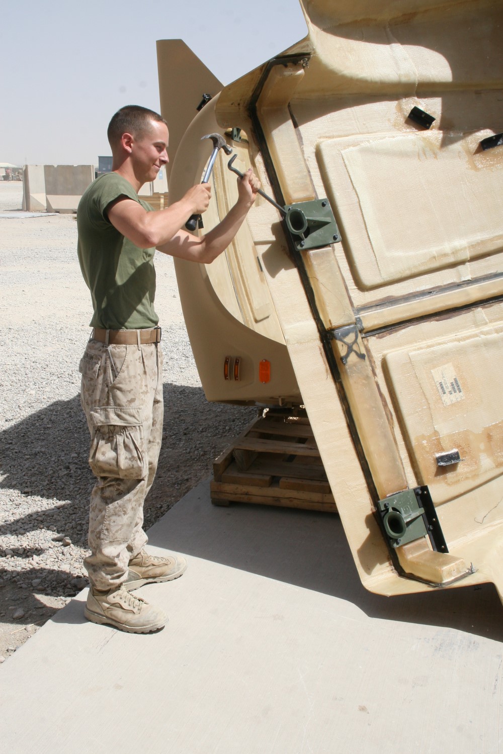 Corporal Jordan A. Yokum, a preservation, packaging and packing specialist with Redeployment and Retrograde in support of Reset and Reconstitution Operations Group, works on a piece of equipment that was removed from a tactical vehicle aboard Camp Leatherneck, Helmand province, Afghanistan, July 1, 2014. R4OG was established during April 2012 and has a significant role as the unit responsible for bringing all Marine Corps gear home from Afghanistan.