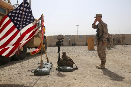 Sergeant Louis Wood, scout sniper, Scout Sniper Platoon, 1st Battalion, 7th Marine Regiment, and a native of Fort Worth, Texas, salutes a battlefield cross during a memorial ceremony aboard Camp Leatherneck, July 2, 2014. The memorial was in honor of Sgt. Thomas Z. Spitzer, a professionally instructed gunman with Scout Sniper Platoon, 1st Bn., 7th Marines, who was killed while conducting combat operations in Helmand province, Afghanistan, June 25, 2014. (U.S. Marine Corps photo by Cpl. Joseph Scanlan / released)