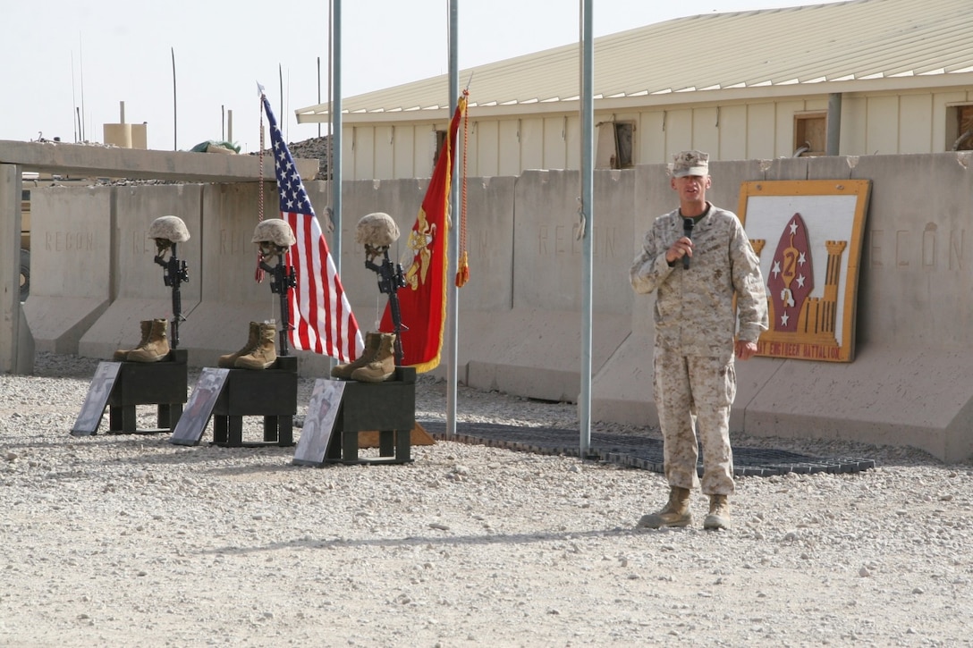 Lieutenant Col. John C. Osborne, commanding officer, 2nd Combat Engineer Battalion, addresses guests during a memorial ceremony to pay respect to three Marine heroes aboard Camp Leatherneck, Afghanistan, July 8, 2014. Three battlefield crosses stand in honor of Staff Sgt. David H. Stewart, a combat engineer, platoon sergeant and native of Stafford, Virginia; Cpl. Brandon J. Garabrant, a combat engineer and native of Peterborough, New Hampshire; and Cpl. Adam F. Wolff, a combat engineer and native of Cedar Rapids, Iowa, all Marines serving with 3rd Platoon, Route Clearance Company, 2nd CEB, who gave the ultimate sacrifice while conducting combat operations in Helmand province, Afghanistan, June 20, 2014.