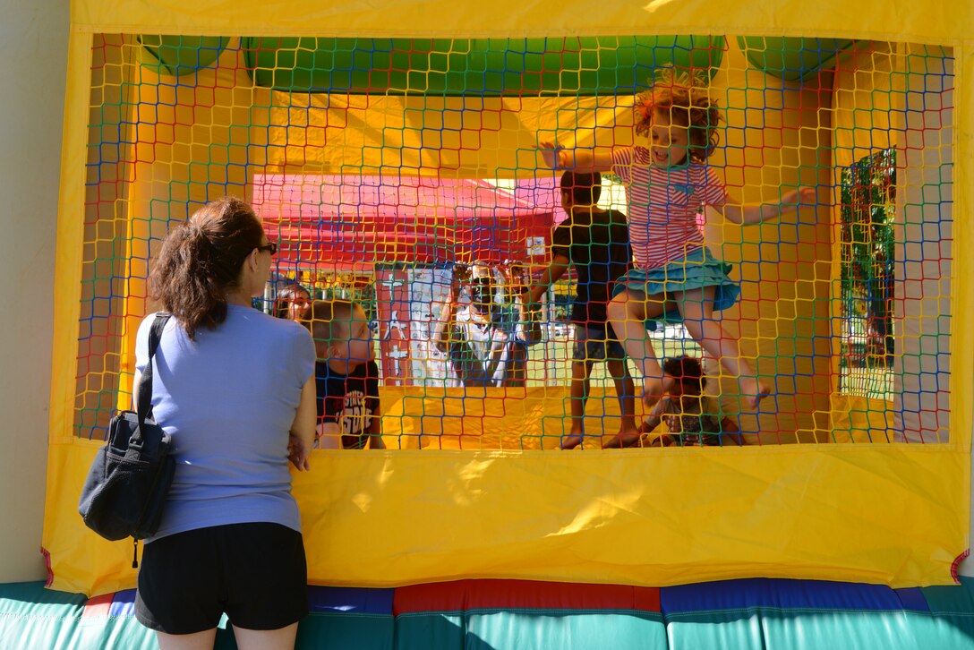 Children bounce in the moon bounce as their parents watch during the Independence Day Celebration on Lejeune Field July 4, 2014. The celebration started at 3 p.m. and went until 9:30 p.m. 