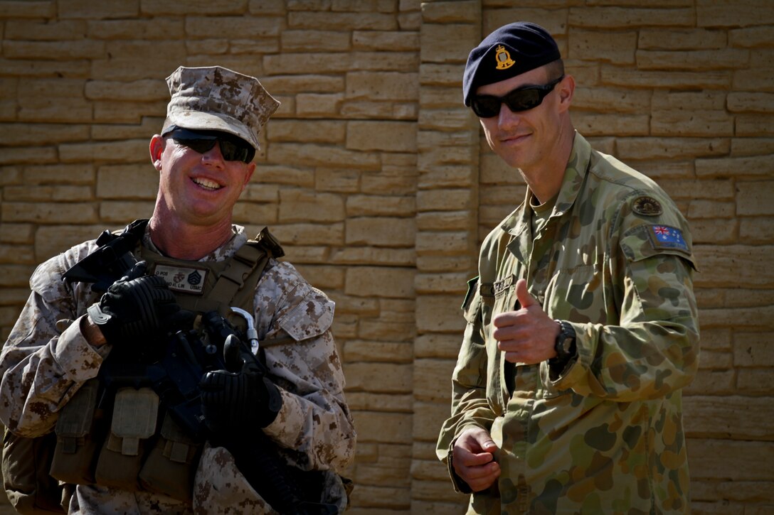 U.S. Marine Staff Sgt. Larry Newland,Company Gunnery Sgt., Combined Landing Team 2, and Australian Defense Forces Cpl. Ross Campbell, Quartermaster, 5th Royal Australian Regiment, pose for a photo prior to conducting Military Operations on Urban Terrain (MOUT) as part of the Rim of the Pacific (RIMPAC) Exercise on July 3, 2014 at Marine Corps Base Hawaii, Kaneohe Bay. This year marks the 24th exercise in the series that began in 1971. The exercise is hosted by Commander, U.S. Pacific Fleet, in and around the islands of Hawaii. RIMPAC 2014 takes place from June 26 to Aug. 1, and includes events in port as well as underway. 