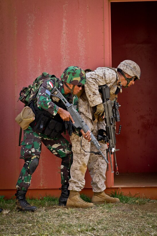 A U.S. Marine and Indonesian Marine stack together in preparation for clearing a building during Military Operations in Urban Terrain (MOUT) training at Marine Corps Base Hawaii, Kaneohe Bay, July 3, 2014 as part of the Rim of the Pacific 2014 (RIMPAC) Exercise. This year marks the 24th exercise in the series that began in 1971. The exercise is hosted by Commander, U.S. Pacific Fleet, in and around the islands of Hawaii. RIMPAC 2014 takes place from June 26 to Aug. 1, and includes events in port as well as underway. (U.S. Marine Corps photo by Sgt. William L. Holdaway//RELEASED)