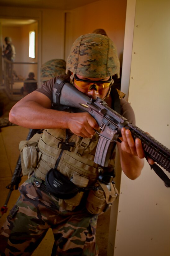 U.S. Marines and Royal Tongan Marines clear a simulated enemy occupied building during Military Operations in Urban Terrain (MOUT) training at Marine Corps Base Hawaii, Kaneohe Bay, July 3, 2014 as part of the Rim of the Pacific 2014 (RIMPAC) Exercise. This year marks the 24th exercise in the series that began in 1971. The exercise is hosted by Commander, U.S. Pacific Fleet, in and around the islands of Hawaii. RIMPAC 2014 takes place from June 26 to Aug. 1, and includes events in port as well as underway. (U.S. Marine Corps photo by Sgt. William L. Holdaway//RELEASED)