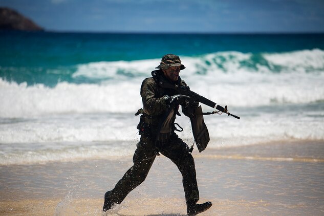 A soldier with the Japan Ground Self-Defense Force (JGSDF) sprints to take a position on the beach to secure a perimeter during an amphibious assault at Pyramid Rock Beach. The JGSDF conducted the training exercise with U.S. Marines with 3rd Reconnaissance Battalion, based in Okinawa, Japan. The world's largest international maritime exercise, Rim of the Pacific (RIMPAC) Exercise 2014, provides a unique training opportunity that helps participants foster and sustain the cooperative relationships that are critical to ensuring the safety of sea lanes and security on the world's oceans. Twenty-two nations, more than 40 ships, six submarines, more than 200 aircraft and 25,000 personnel are participating in RIMPAC.