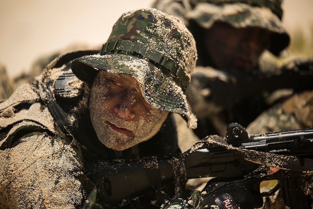 A soldier with the Japan Ground Self-Defense Force (JGSDF) waits for his squad leader to give the signal to advance positions during an amphibious assault at Pyramid Rock Beach. The JGSDF conducted the training exercise with U.S. Marines with 3rd Reconnaissance Battalion, based in Okinawa, Japan. The world's largest international maritime exercise, Rim of the Pacific (RIMPAC) Exercise 2014, provides a unique training opportunity that helps participants foster and sustain the cooperative relationships that are critical to ensuring the safety of sea lanes and security on the world's oceans. Twenty-two nations, more than 40 ships, six submarines, more than 200 aircraft and 25,000 personnel are participating in RIMPAC.