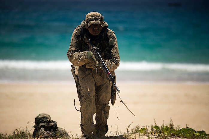 A Japan Ground Self-Defense Force (JGSDF) soldier advances positions while his squad member provides cover during an amphibious assault at Pyramid Rock Beach. The JGSDF conducted the training exercise with U.S. Marines with 3rd Reconnaissance Battalion, based in Okinawa, Japan. The world's largest international maritime exercise, Rim of the Pacific (RIMPAC) Exercise 2014, provides a unique training opportunity that helps participants foster and sustain the cooperative relationships that are critical to ensuring the safety of sea lanes and security on the world's oceans. Twenty-two nations, more than 40 ships, six submarines, more than 200 aircraft and 25,000 personnel are participating in RIMPAC.