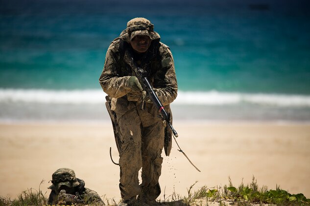 A Japan Ground Self-Defense Force (JGSDF) soldier advances positions while his squad member provides cover during an amphibious assault at Pyramid Rock Beach. The JGSDF conducted the training exercise with U.S. Marines with 3rd Reconnaissance Battalion, based in Okinawa, Japan. The world's largest international maritime exercise, Rim of the Pacific (RIMPAC) Exercise 2014, provides a unique training opportunity that helps participants foster and sustain the cooperative relationships that are critical to ensuring the safety of sea lanes and security on the world's oceans. Twenty-two nations, more than 40 ships, six submarines, more than 200 aircraft and 25,000 personnel are participating in RIMPAC.