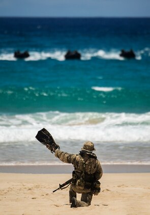 A Japan Ground Self-Defense Force (JGSDF) squad leader signals the rest of his team to come to shore during an amphibious assault at Pyramid Rock Beach. The JGSDF conducted the training exercise with U.S. Marines with 3rd Reconnaissance Battalion, based in Okinawa, Japan. The world's largest international maritime exercise, Rim of the Pacific (RIMPAC) Exercise 2014, provides a unique training opportunity that helps participants foster and sustain the cooperative relationships that are critical to ensuring the safety of sea lanes and security on the world's oceans. Twenty-two nations, more than 40 ships, six submarines, more than 200 aircraft and 25,000 personnel are participating in RIMPAC. 