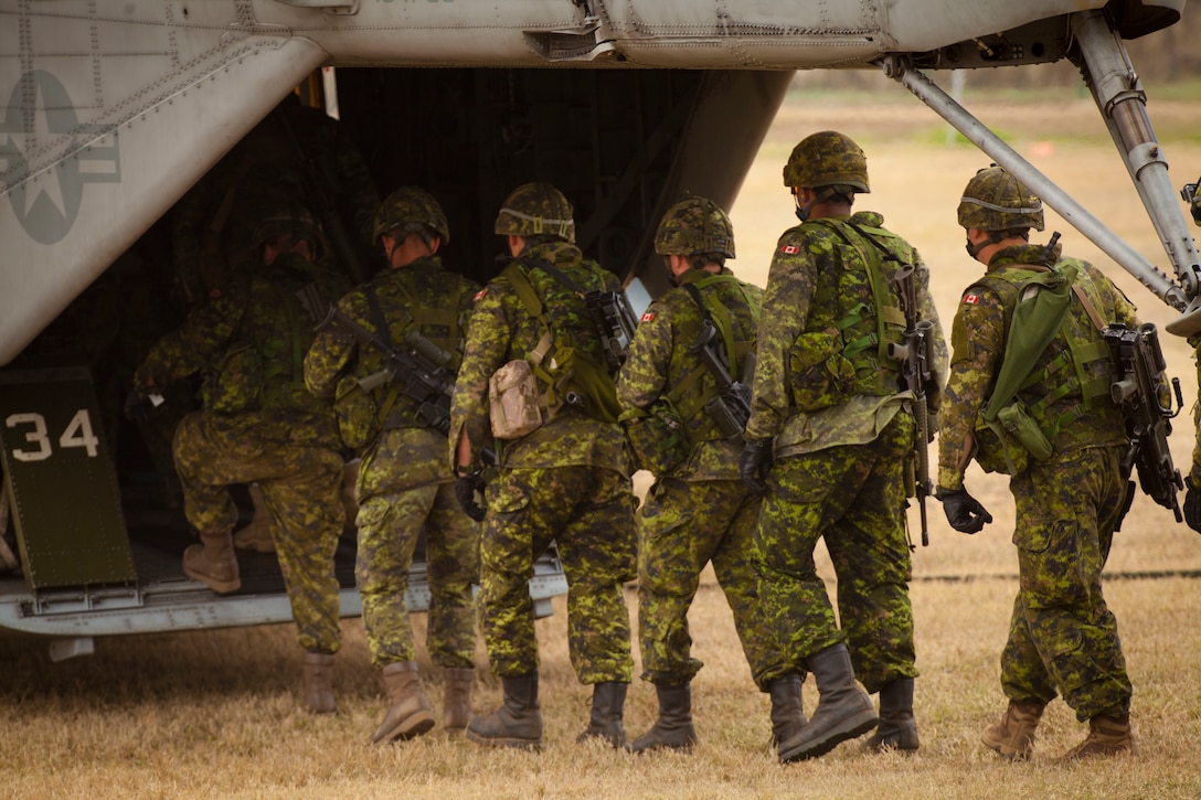 Canadian Soldiers with Charlie Company, 3rd Battalion, Princess Patricias Canadian Light Infantry (PPCLI), enter the back of a CH-53E Super Stallion prior fast roping from the helicopter during Rim of the Pacific (RIMPAC) Exercise 2014 at Landing Zone Eagle. Twenty-two nations, 49 ships, 6 submarines, more than 200 aircraft and 25,000 personnel are participating in RIMPAC from June 26 to Aug. 1, in and around the Hawaiian Islands and Southern California. The world's largest international maritime exercise, RIMPAC provides a unique training opportunity that helps participants foster and sustain the cooperative relationships that are critical to ensuring the safety of sea lanes and security on the world's oceans. RIMPAC 2014 is the 24th exercise in the series that began in 1971.  (U.S. Marine Corps photo by Lance Cpl. Aaron S. Patterson/Released)