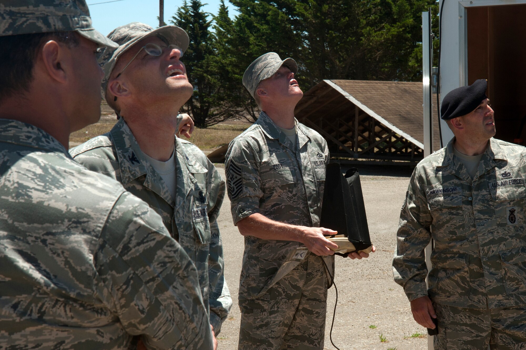 Chief Master Sgt. of the Air Force, James A. Cody, and 30th Mission Support Group leaders, look to the sky to watch a demonstration flight of the Raven-B Digital Data Link, July 8, 2014, Vandenberg Air Force Base, Calif. The Raven-B/DDL is an unmanned aerial vehicle operated by the 30th Security Forces Squadron and Vandenberg is the only stateside base with a Raven mission. (U.S. Air Force photo by Michael Peterson/Released)