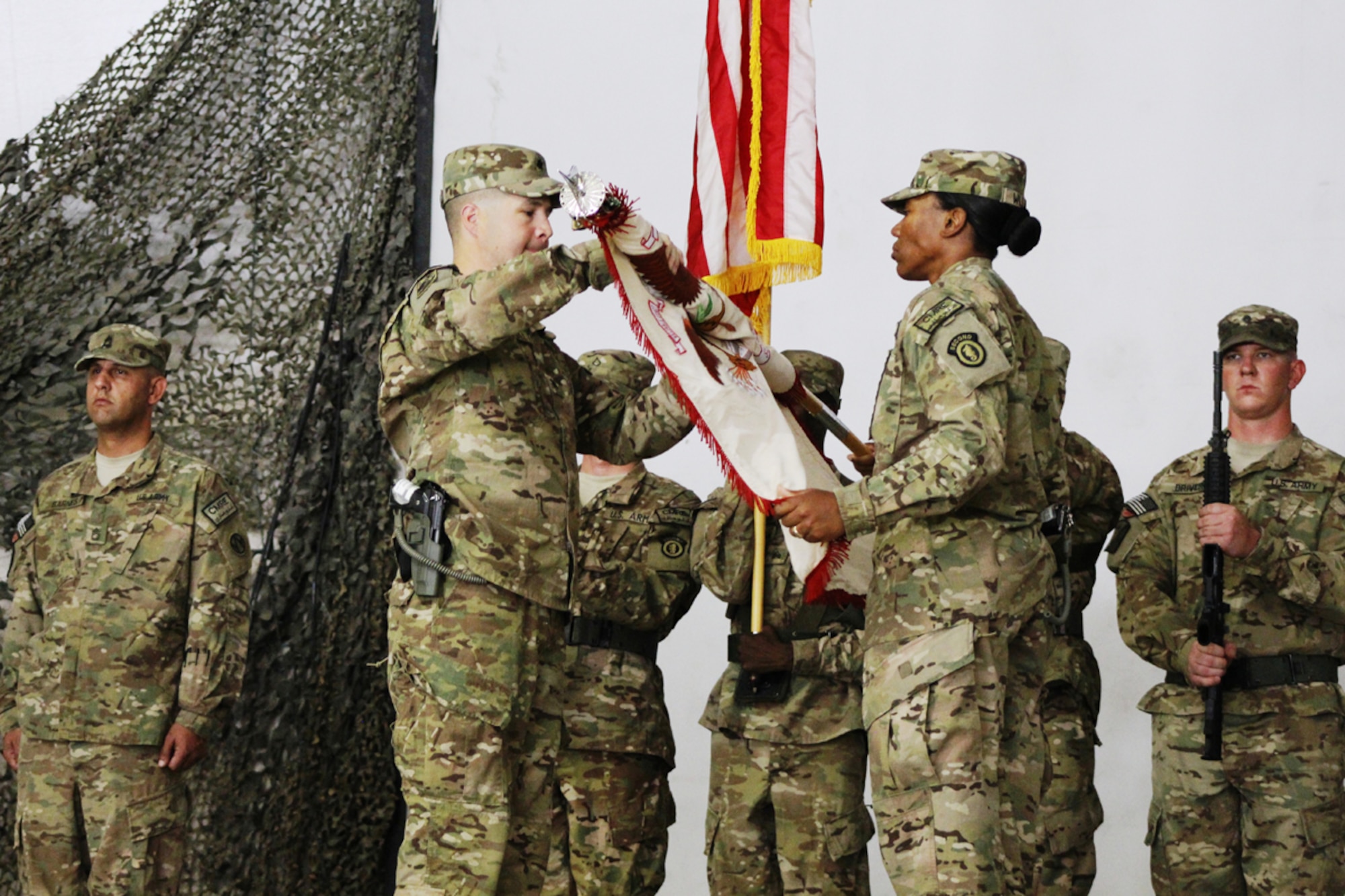 Army Lt. Col. Brian Formy-Duval and Command Sgt. Maj. Jacqueline Williams, the command team of 17th Combat Sustainment Support Battalion, uncase the unit colors during a transfer-of-authority ceremony July 1 in Afghanistan. (Courtesy photo)
