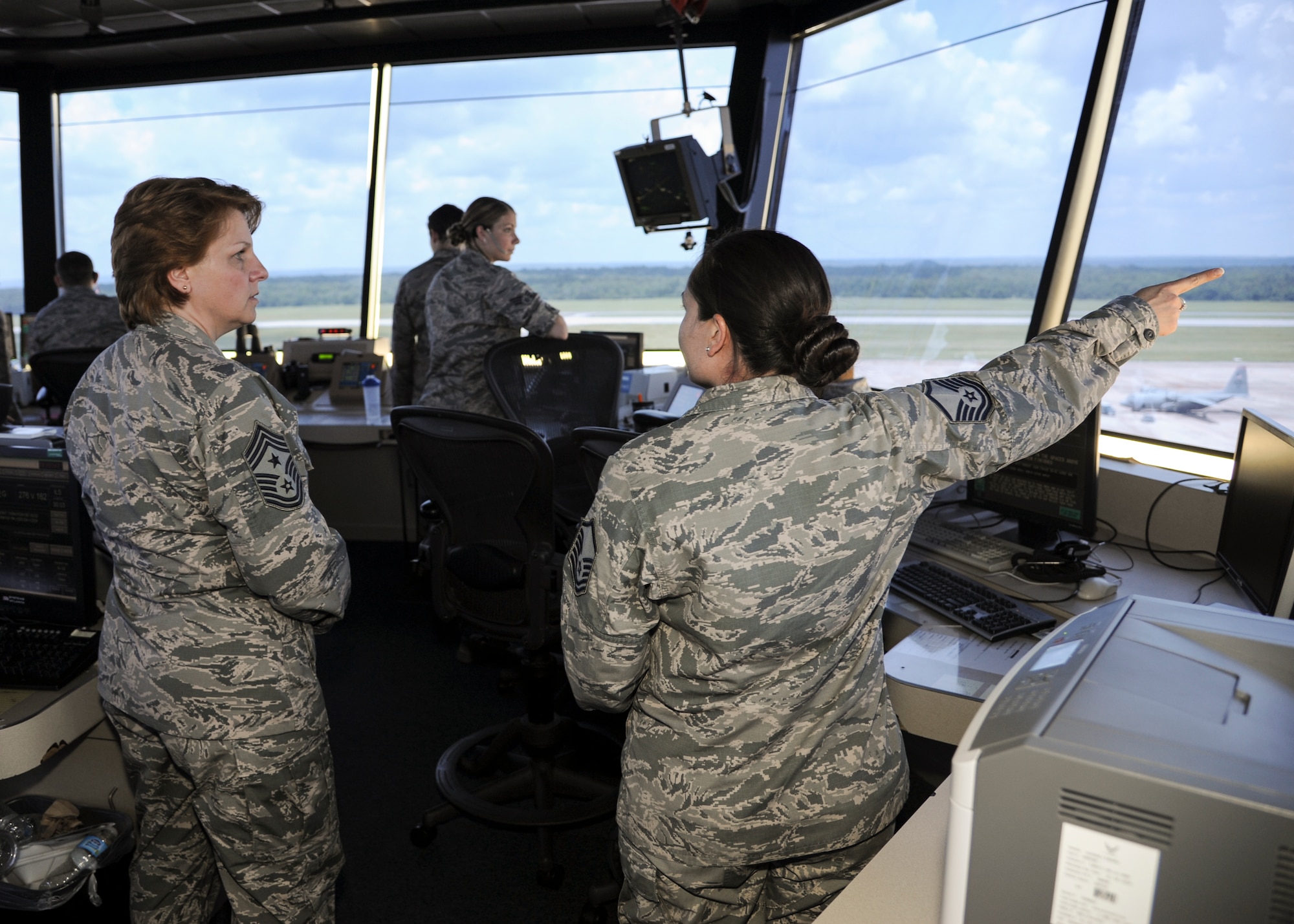 Chief Master Sgt. Rhonda Buening, 19th Airlift Wing command chief, is briefed on air traffic control operations by Master Sgt. Kristi Lott, 19th Operations Support Squadron chief controller, June 3, 2014, at Little Rock Air Force Base, Ark.  Buening frequently visits various units across the base to connect with Airmen.  (U.S. Air Force photo by Airman 1st Class Harry Brexel)