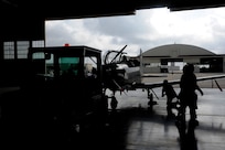 Maintenance personnel roll a T-6 Texan II into a hangar July 9, 2014 at Joint Base San Antonio-Randolph. City of San Antonio firefighters visited JBSA-Randolph to learn how to properly respond to an emergency involving a T-6 Texan II. The familiarization training was intended to bring firefighters together to prepare for emergencies. (U.S. Air Force photos by A1C Stormy D. Archer/Released)