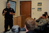 Time Hagan, Joint Base San Antonio-Randolph firefighter, briefs a group of San Antonio and JBSA-Randolph firefighters about the possible safety hazards of extricating a pilot from a T-6 Texan II July 9, 2014 at JBSA-Randolph. The firefighters trained together to improve emergency response involving military aircraft. (U.S. Air Force photos by A1C Stormy D. Archer/Released)