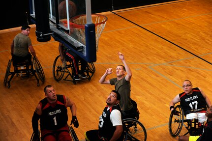 The Army team scrimmages the Marine team July 9, 2014, during the 2014 Wounded Warrior Summer Invitational Adaptive Sports Tournament at the Rambler Fitness Center at Joint Base San Antonio-Randolph, Texas. The event features 100 wounded warriors from both the U.S. and the United Kingdom. The event is leading up to two other events beginning this September, which are the Warrior Games being held in Colorado Springs, Colorado, and the Invictus Games being held in the U.K. The three-day event included skill development and tournament competition in wheelchair basketball and sitting volleyball for the wounded warriors from the U.S. Air Force, Army, Marine Corps and Great Britain. (U.S. Air Force photo/Desiree N. Palacios)

