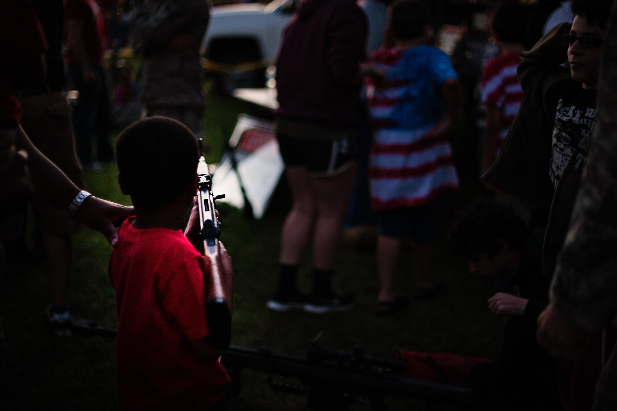 Tyler Ellis, 5-year-old son of Staff Sgt. Lexington and Vivian Ellis, looks through the scope of a weapon during Joint Base McGuire-Dix-Lakehurst’s 2014 Independence Day Open House held at Doughboy Field, July 4, 2014. More than 25,000 people attended the event that featured traditional Fourth of July foods, fireworks, games and music. (U.S. Air Force photo/Staff Sgt. Katherine Tereyama)