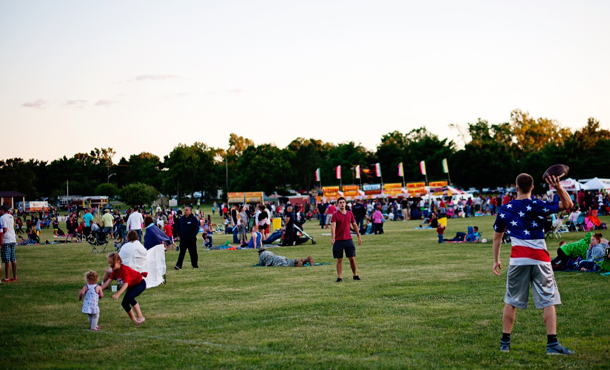 Will Lemay, a Mt. Laurel resident, throws a football during Joint Base McGuire-Dix-Lakehurst’s 2014 Independence Day Open House held at Doughboy Field, July 4, 2014. More than 25,000 people attended the event that featured traditional Fourth of July foods, fireworks, games and music. (U.S. Air Force photo/Staff Sgt. Katherine Tereyama)