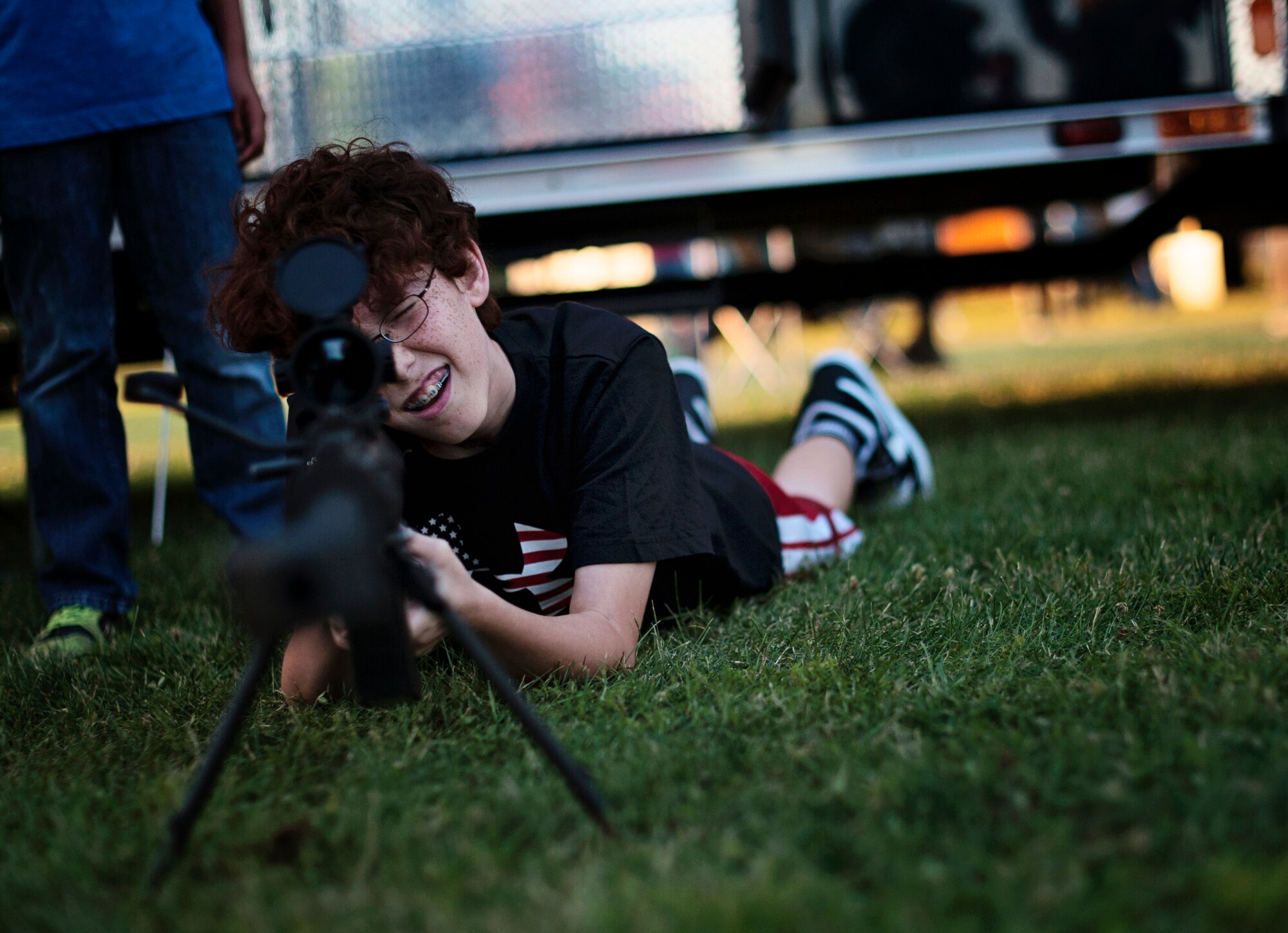 Cody Choate, 8-year-old son of Senior Master Sgt. Clayton Choate, 305th Aircraft Maintenance Squadron, looks through the scope of a weapon during Joint Base McGuire-Dix-Lakehurst’s 2014 Independence Day Open House held at Doughboy Field, July 4, 2014. More than 25,000 people attended the event that featured traditional Fourth of July foods, fireworks, games and music. (U.S. Air Force photo/Staff Sgt. Katherine Tereyama)