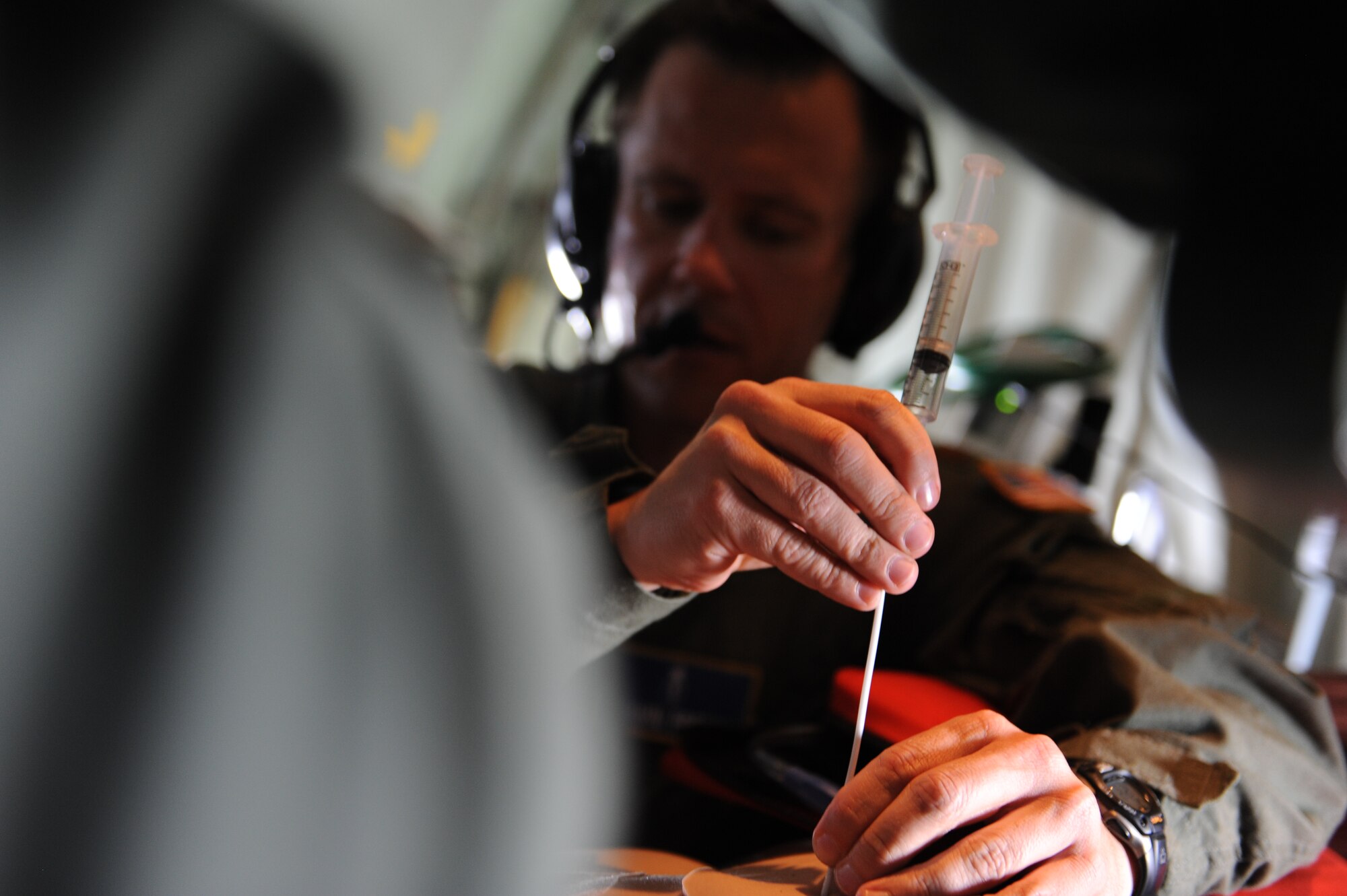 Maj. Shawn French, 81st Medical Operations Squadron, tends to a simulated patient during a total force medical airlift training exercise July 9, 2014, Keesler Air Force Base, Miss. Operation Magnolia Medical En Route Care simulated a medical extraction during an imminent hurricane, and highlighted the 53rd Weather Reconnaissance Squadron Hurricane Hunters, 81st Medical Group's Critical Care Air Transport and Tactical Critical Care Evacuation Team, as well as other local Mississippi Air National Guard units.