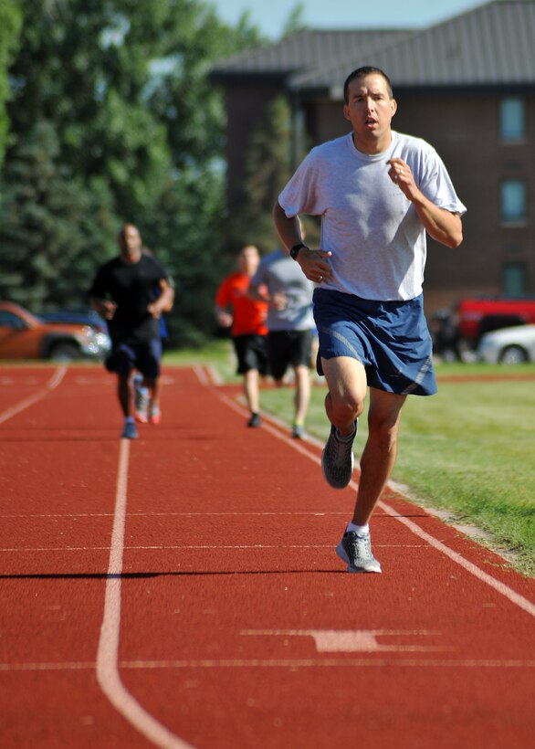 First Lt. Jon Datsko, 319th Air Base Wing Staff Agencies executive officer, runs the second lap of the 1.5-mile run during the individual competitions of the Triple 8 Fitness Challenge on Grand Forks Air Force Base, N.D, July 9, 2014. The Triple 8 Fitness Challenge is a premier fitness event designed to test the physical conditioning limits of Air Force athletes. The event challenges Airmen to run 1.5 miles in under nine minutes, as well as perform at least 80 push-ups and 80 sit-ups each in one minute or less. (U.S. Air Force photo/Senior Airman Xavier Navarro)