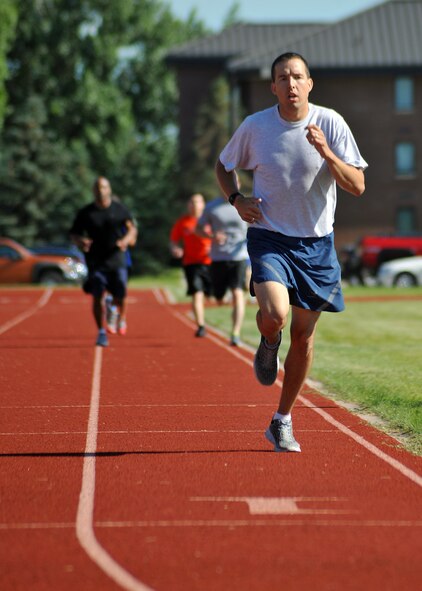 First Lt. Jon Datsko, 319th Air Base Wing Staff Agencies executive officer, runs the second lap of the 1.5-mile run during the individual competitions of the Triple 8 Fitness Challenge on Grand Forks Air Force Base, North Dakota, July 9, 2014. The Triple 8 Fitness Challenge is a premier fitness event designed to test the physical conditioning limits of Air Force athletes. The event challenges Airmen to run 1.5 miles in under nine minutes, as well as perform at least 80 push-ups and 80 sit-ups each in one minute or less. (U.S. Air Force photo/Senior Airman Xavier Navarro) 

