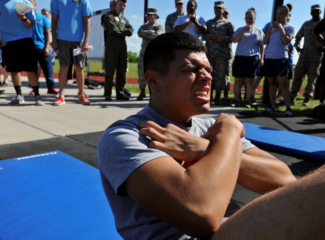 Senior Airman Kevin Ramos, 319th Logistics Readiness Squadron flight service center journeyman, performs a sit-up during the Triple 8 Fitness Challenge on July 9, 2014 on Grand Forks Air Force Base, N.D. Ramos completed 85 sit-ups in one minute as part of the team event. (U.S. Air Force photo/Senior Airman Xavier Navarro)
