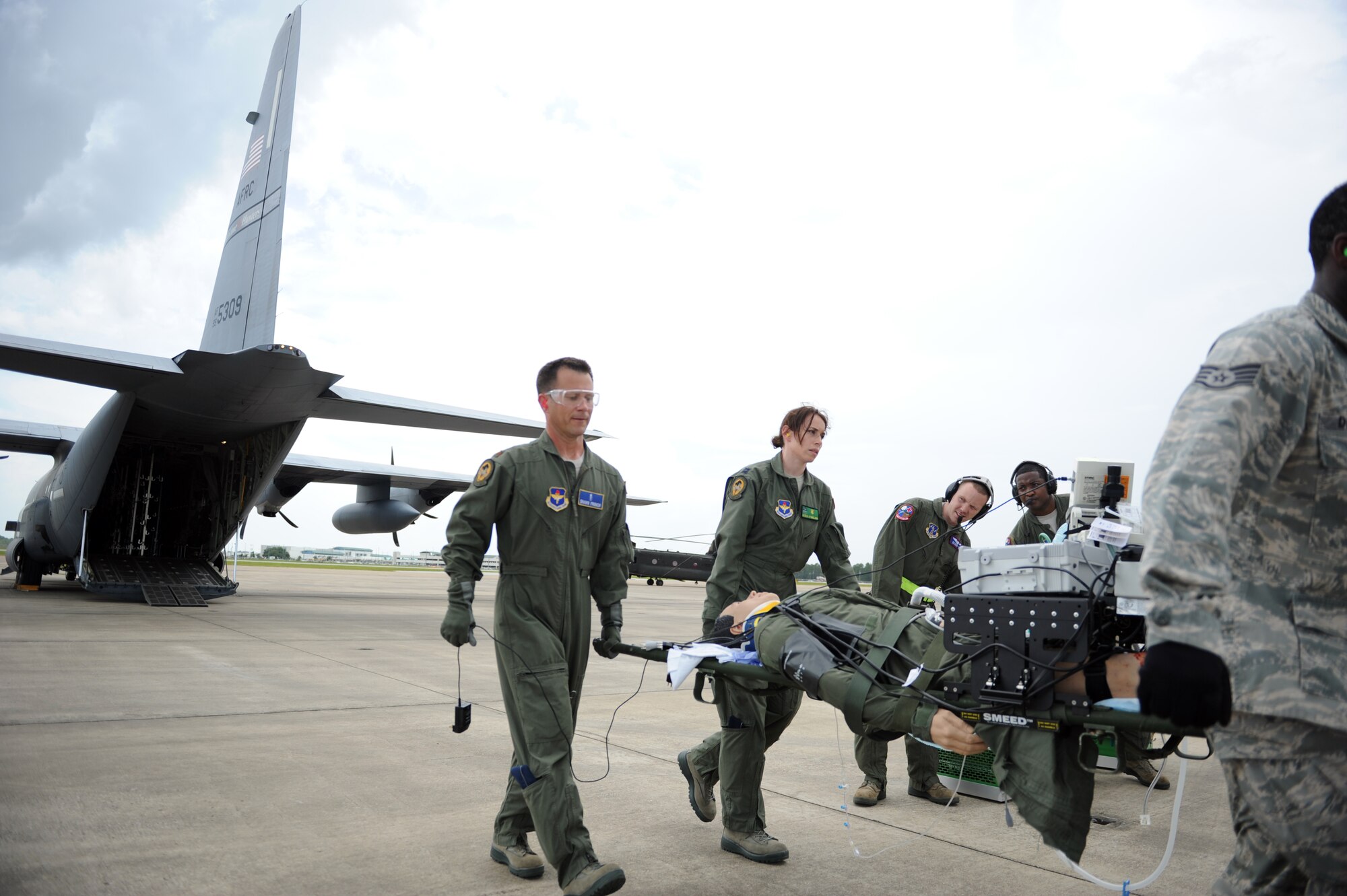 Maj. Shawn French, 81st Medical Operations Squadron, and Capt. Karen Stimeling, 81st Inpatient Operations Squadron, carry a simulated patient from a WC-130J during a total force medical airlift training exercise July 9, 2014, at the Gulfport Combat Readiness Training Center in Gulfport, Miss. Operation Magnolia Medical En Route Care simulated a medical extraction during an imminent hurricane, and highlighted the 53rd Weather Reconnaissance Squadron Hurricane Hunters, 81st Medical Group's Critical Care Air Transport and Tactical critical care evacuation team, as well as other local Mississippi Air National Guard units.
