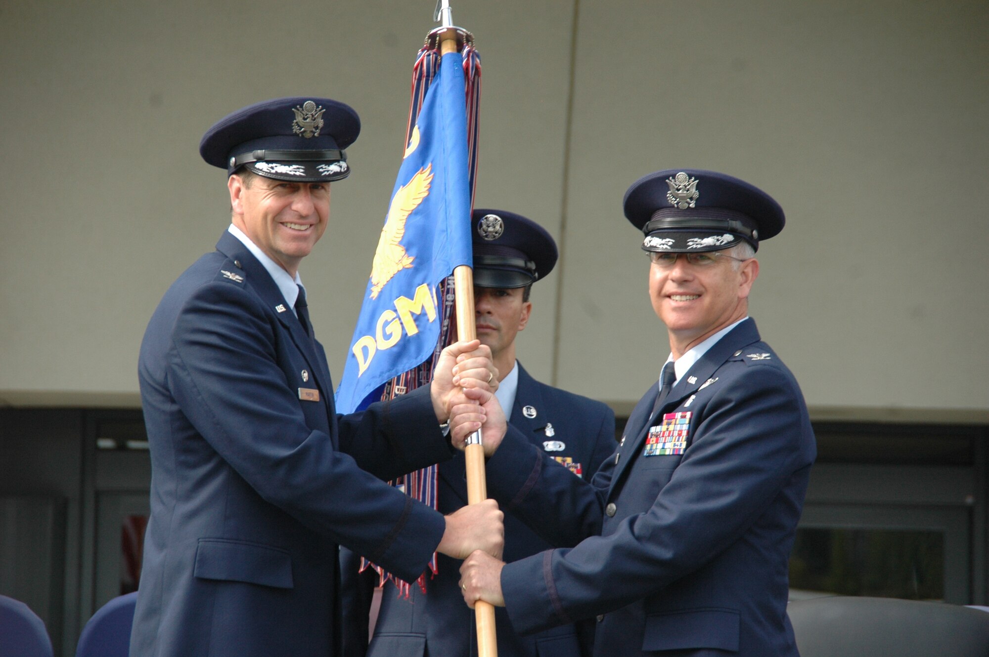 Col. (Dr.) Rawson Wood (right), incoming 60th Medical Group commander, accepts the ceremonial guidon from Col. Corey Martin, 60th Air Mobility Wing commander during a change of command ceremony held July 7 on the north lawn of David Grant USAF Medical Center.  (U.S. Air Force photo / Jim Spellman)