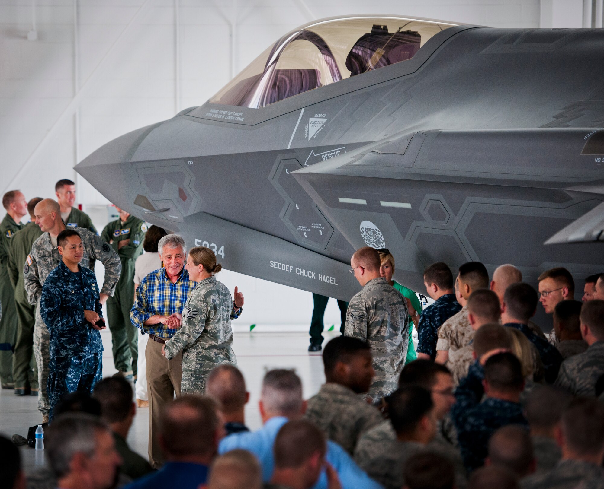Defense Secretary Chuck Hagel meets a 33rd Fighter Wing Airman after a troop call July 10 at Eglin Air Force Base, Fla.  Hagel visited the base to tour the wing and the F-35 Lightning II integrated training center.  He held a 45-minute troop call to praise the work of the service members who began and continue to improve the DOD’s newest fighter program.  (U.S. Air Force photo/Samuel King Jr.)