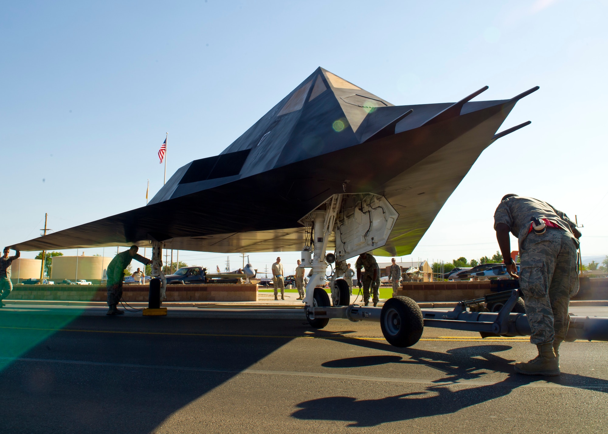 Members of Team Holloman position the F-117 Nighthawk into Heritage Airpark at Holloman Air Force Base, N.M., June 28.  The F-117 has been on static display in Holloman’s Heritage Airpark since its retirement in 2008. Due to sun and inclement weather damage, the 49th Maintenance Squadron removed and towed the aircraft to begin the restoration process. The aircraft received structural maintenance, and a fresh paint job before it was returned for display in Heritage Airpark. (U.S. Air Force photo by Airman 1st Class Leah Ferrante/Released)

