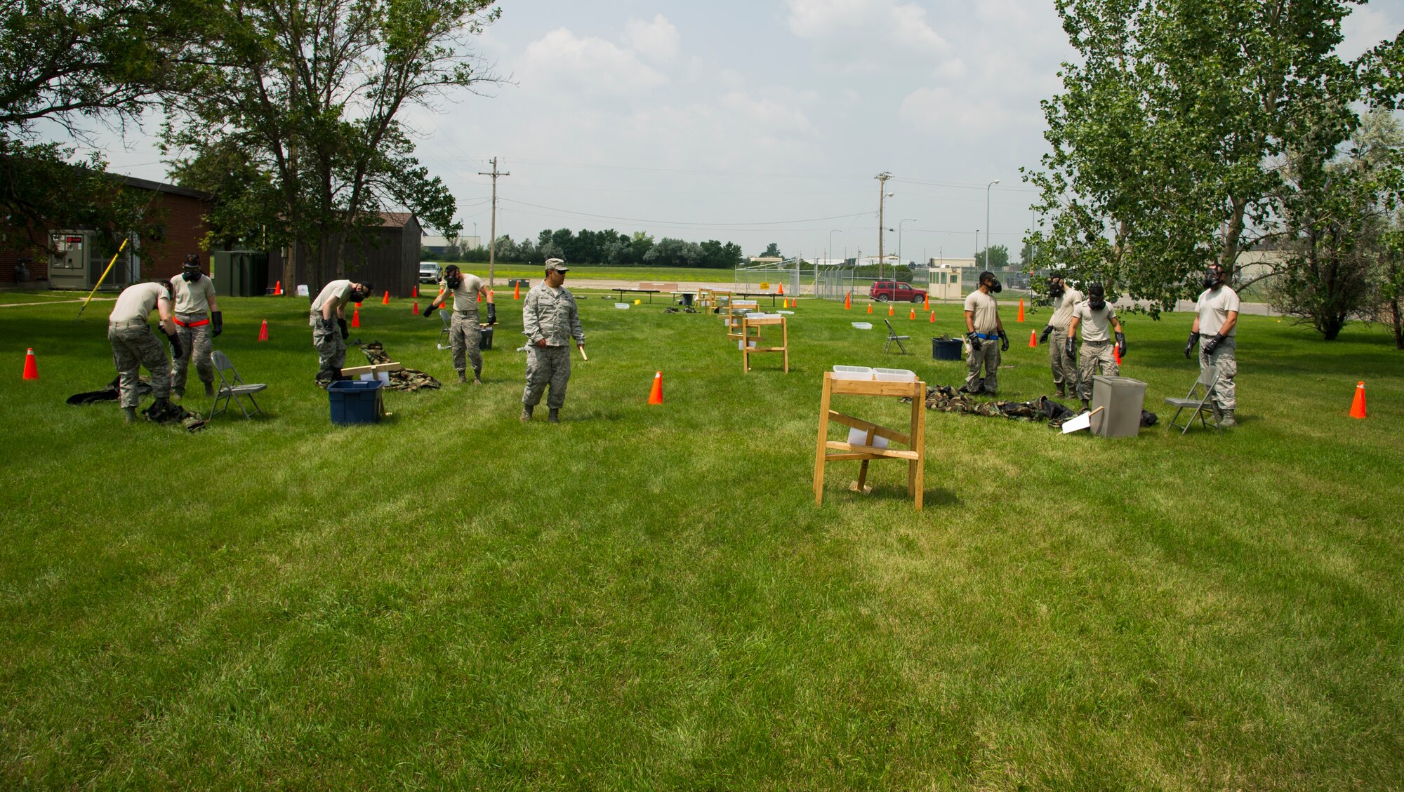 Airmen from the 5th Aircraft Maintenance Squadron work through a course to test their overall knowledge of removing their personal protective equipment during an Ability to Survive and Operate Training course on Minot Air Force Base, N.D., July 8, 2014. The training was conducted to teach Airmen how to safely add and take off gear. (U.S. Air Force photo/Senior Airman Andrew Crawford)