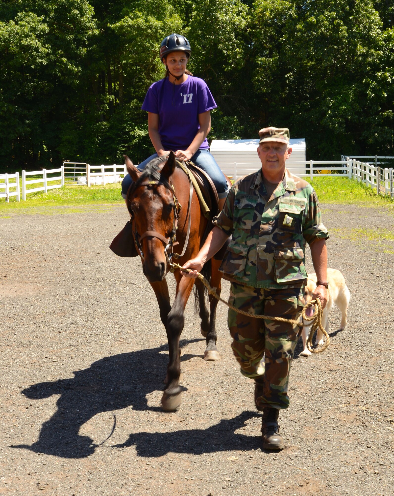 Gabrielle Martucci, 14, rides horse, Wes, as Capt. Edward Henfey, commanding officer of the First Company Governor's Horse Guard, leads the way in Avon, Conn., June 21, 2014. Gabrielle was a participant in the Horses to Homecoming program, which helps military children reconnect with their parents. (U.S. Air National Guard photo by Senior Airman Jennifer Pierce)