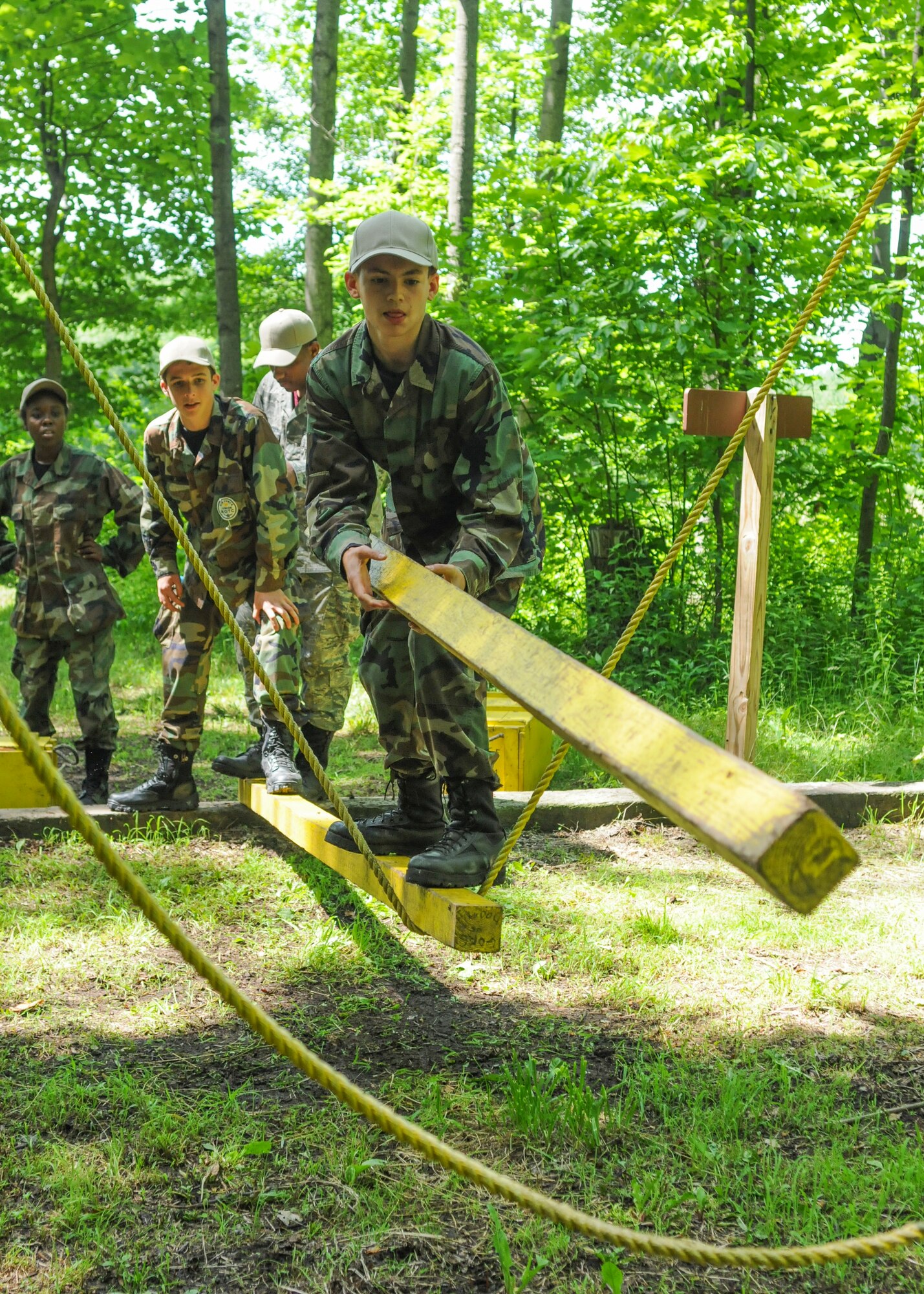 Junior Reserve Officer Training Corps (JROTC) cadets work on solving a rope course obstacle at Camp Ravenna, Ohio, June 27th, 2014. Approximately 30 JROTC cadets came to YARS for a four-day leadership development encampment, which included the trip to Camp Ravenna, facilitated by 910th Airlift Wing Airmen. U.S. Air Force photo/Eric M. White.