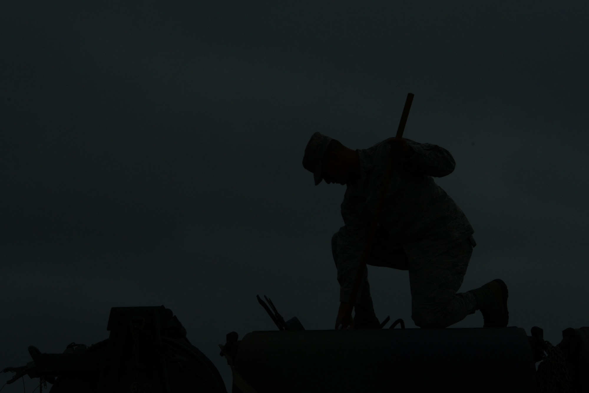 Airman 1st Class Erin Cruz, an aerospace ground equipment technician from the 103rd Air Control Squadron, checks fuel levels from the top of one of the unit’s trucks shortly after sunset during a deployed training exercise at the National Guard Training Center, Sea Girt, N.J., June 10.  Airmen maintained 24-hour satellite connectivity in field conditions with the help of tactical generators and the trucks that fueled them continuously during the deployment.  (U.S. Air National Guard photo by Senior Airman Emmanuel Santiago)