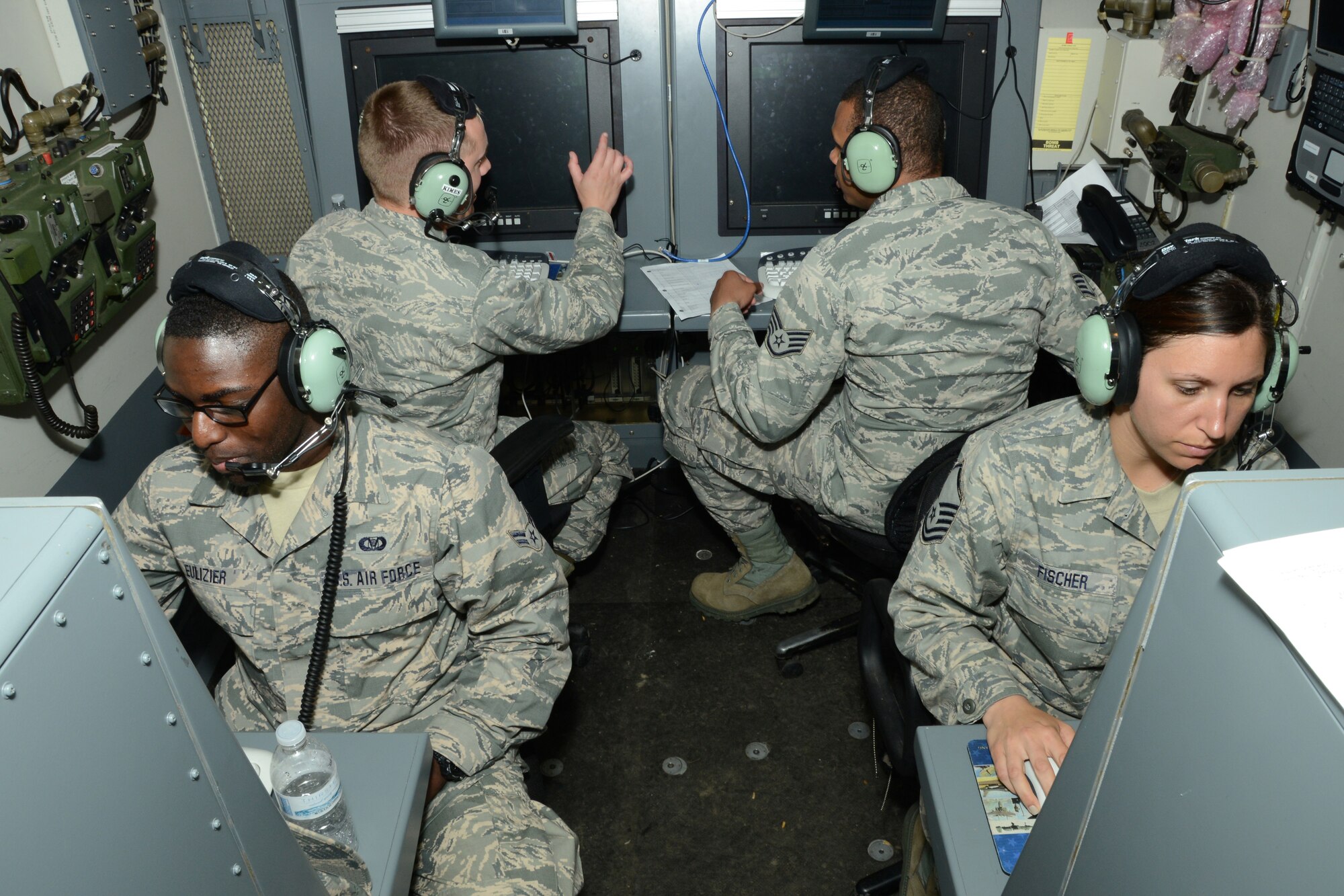 (Front) Airmen 1st Class Layau Eulizer, Master Sgt. Charleen Fischer, (back) Capt. Forrest Kimes and Staff Sgt. Erin Laporte, all from the 103rd Air Control Squadron, perform operational checks inside one of the unit’s operations modules during a deployed training exercise at the National Guard Training Center, Sea Girt, N.J., June 10.  The unit operated in field conditions using satellite communications to facilitate the command and control of simulated military aircraft from the field. (U.S. Air National Guard photo by Senior Airman Emmanuel Santiago)  